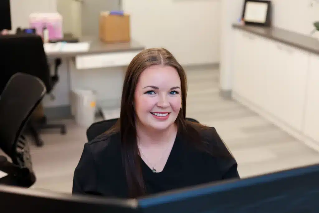 Front desk assistant at our Amarillo dental office smiling.